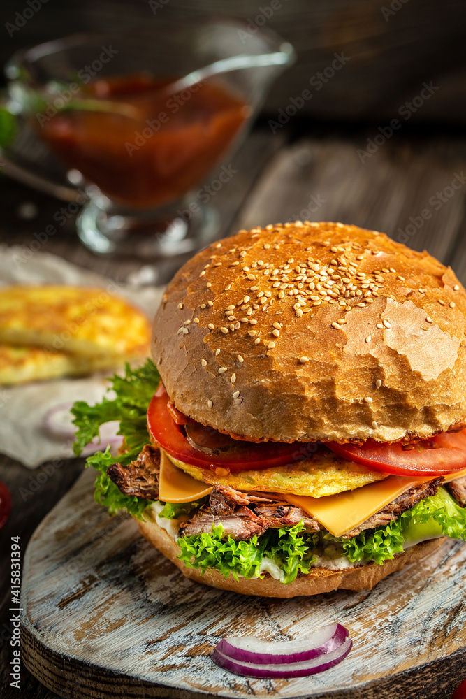 Close-up of tasty homemade burger on rustic wooden background. fast food and junk food concept