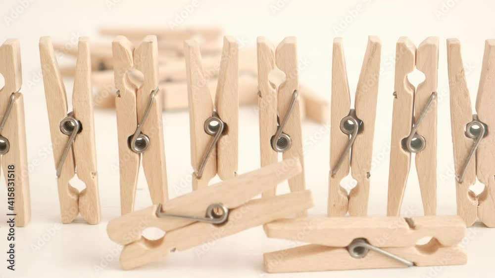 Many wooden clothespins on a white table background. Housework concept Many wooden clothespins on a white table background. Housework concept