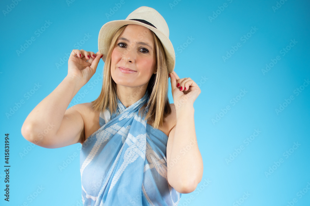 Close up portrait of young smiling woman in straw hat over blue background. Close up portrait of young smiling woman in straw hat over blue background.