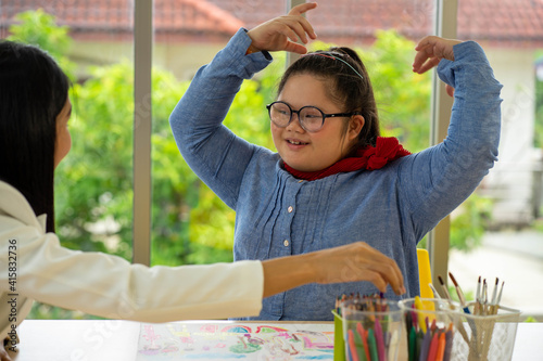 Asian Autism girl playing and learning in special school with young teacher
