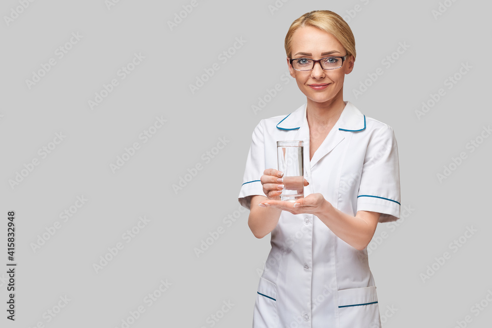 Healthy eating or lifestyle concept - female woman doctor holding and a glass of clear fresh water Healthy eating or lifestyle concept - female woman doctor holding and a glass of clear fresh water