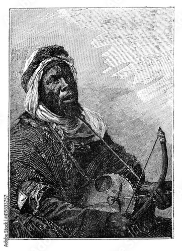 West African griot musician playing a song.Culture and history of West Africa. Vintage antique black and white illustration. 19th century. photo