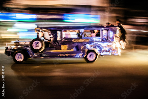 the iconic Philippine jeepney, the king of the road in Metro manila. Jeepney speeding in the streets of Manila.
