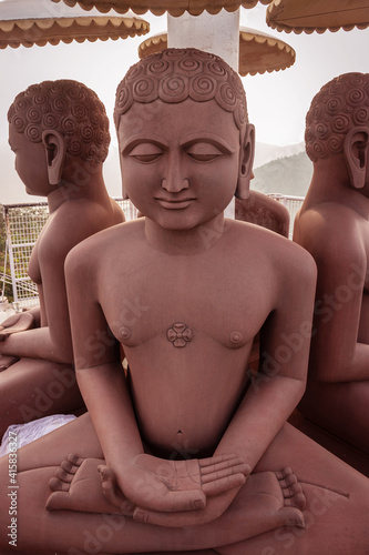 mahavira jain statue made of red stone photo