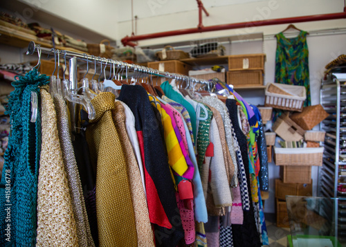 Inside vintage thrift clothing store with fashionable clothing & accessories 