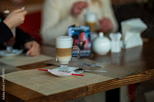 a cup of latte on the table in a cafe