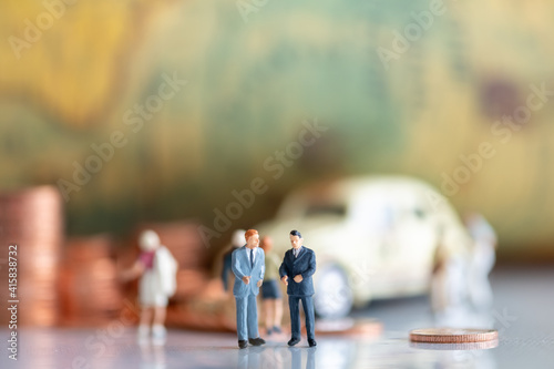 Miniature : Businessman back coin and car background vintage map