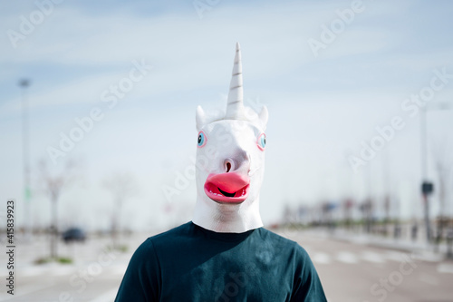 Φωτογραφία man with a unicorn mask outdoors