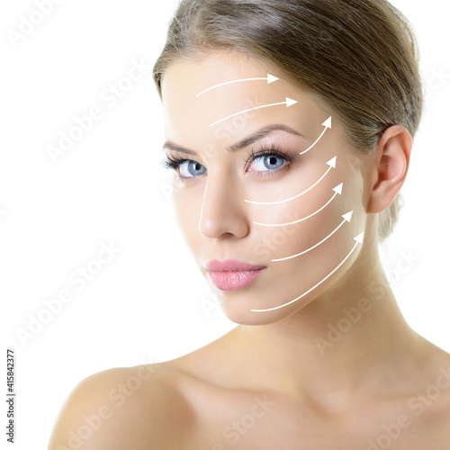 Grid of lines showing facial lifting effect on skin of beautiful young woman with healthy face and nice day makeup looking at camera, studio shot over white background photo