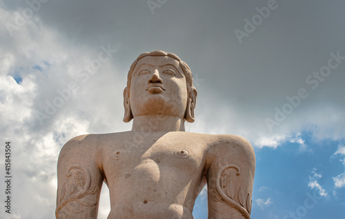 idol of a deity stone statue symbolizing Peace in Jainism with blue sky from different angles photo