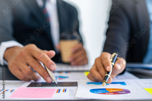 Hands of business people working in the office with documents That represents the investment results of the company Profits between companies that have made a mutual agreement