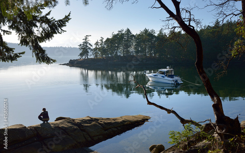 Quadro su tela Women sitting on a rock overlooking Conover Cove, Wallace Island, Gulf Islands,