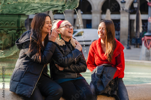 Candid portrait of three women friends having fun in mediterranean city