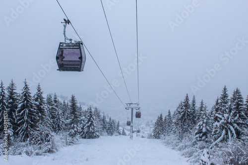 Cable car photographed from Trebevic in winter while it is snowing. Snow in winter on the mountain Trebevic. Sarajevo cable car in nature. Winter and snow.