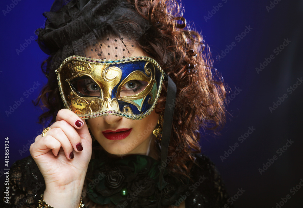 Portrait of woman with artistic make-up holding mask