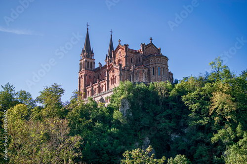 View of the Sanctuary of Covadonga from below at sunset on a summer day. Photograph taken in the Picos de Europa, Asturias, Spain. 