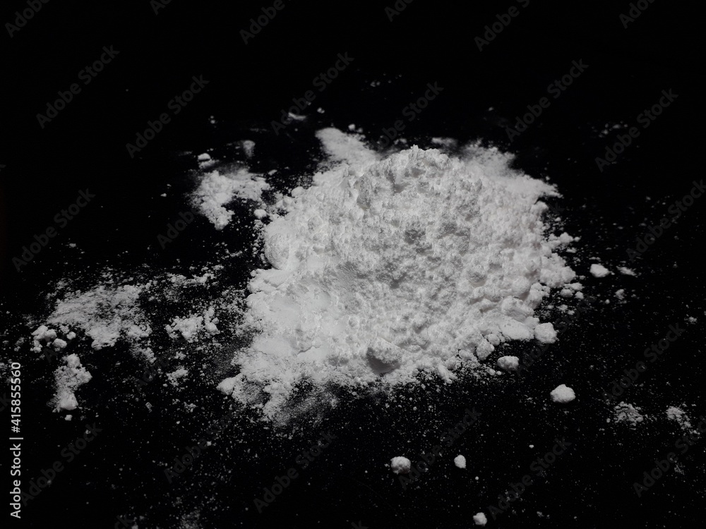 Cocaine drug powder pile on black background Cocaine drug powder pile on black background