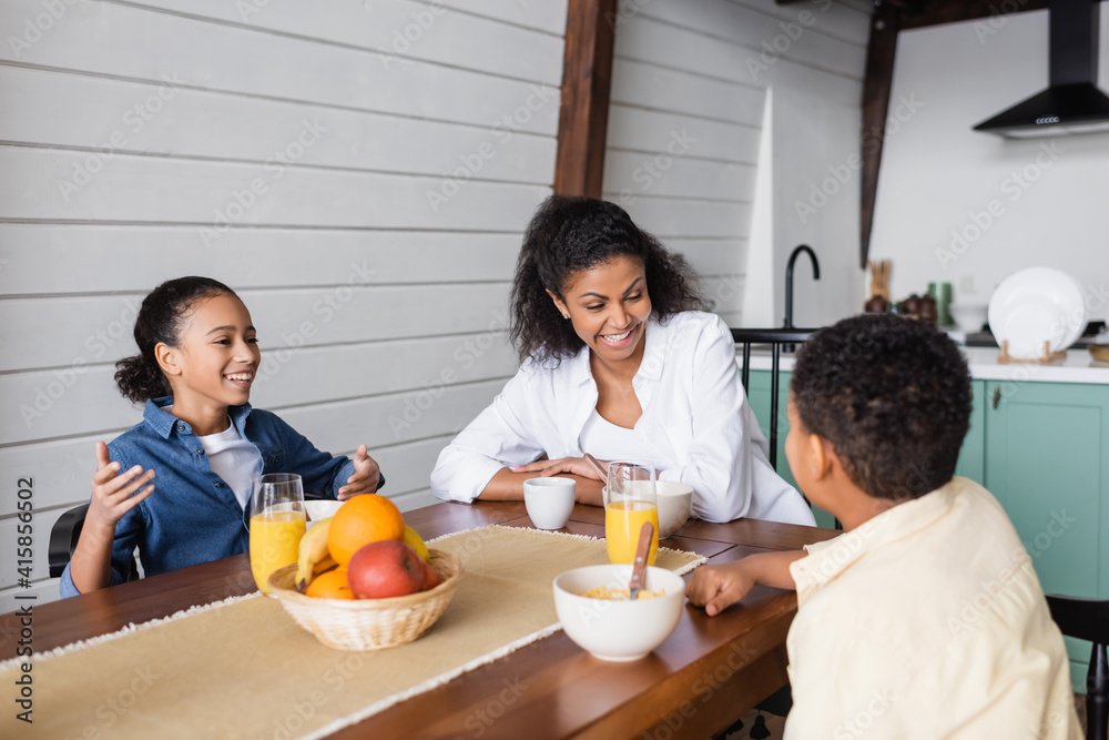 excited african american family laughing during breakfast excited african american family laughing during breakfast