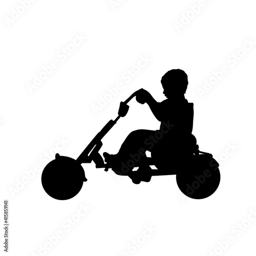Silhouette boy child riding pedal karting