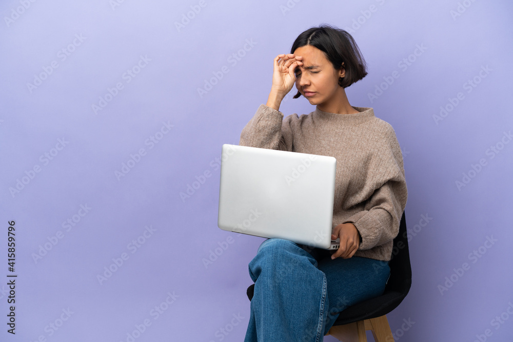 Young mixed race woman sitting on a chair with laptop isolated on purple background with tired and sick expression Young mixed race woman sitting on a chair with laptop isolated on purple background with tired and sick expression