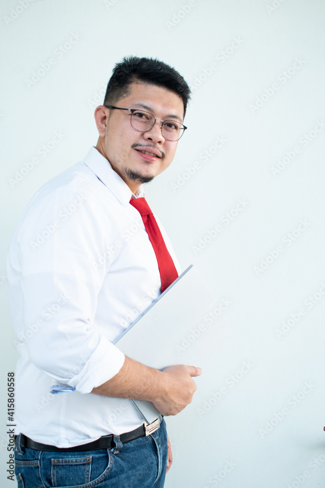 Expert in digital technologies. Cheerful young man in formal wear working on digital tablet and smiling while standing isolated on white background Expert in digital technologies. Cheerful young man in formal wear working on digital tablet and smiling while standing isolated on white background