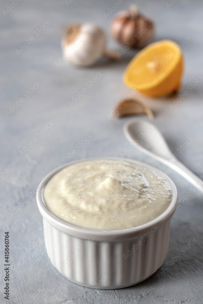 Lebanese Toum garlic sauce. All-purpose garlic sauce (no eggs) as an alternative to mayonnaise. It goes well with all dishes where garlic is appropriate. Selective focus. Lebanese Toum garlic sauce. All-purpose garlic sauce (no eggs) as an alternative to mayonnaise. It goes well with all dishes where garlic is appropriate. Selective focus.