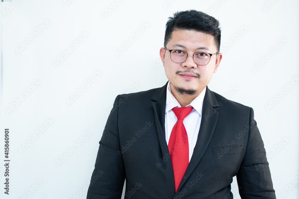 Handsome young business man wear glasses red tie in a suit and west. Handsome young business man wear glasses red tie in a suit and west.