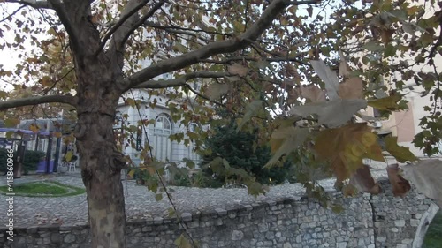 Arch stone bridge in Tirana, Albania. Beautiful trees and buildings photo
