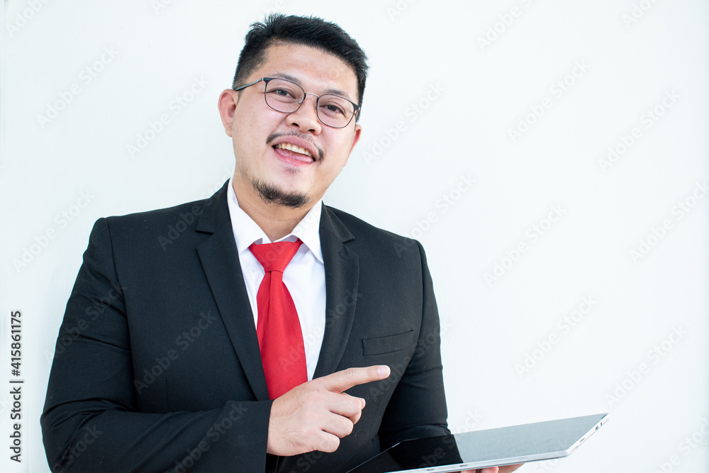 Expert in digital technologies. Cheerful young man in formal wear working on digital tablet and smiling while standing isolated on white background Expert in digital technologies. Cheerful young man in formal wear working on digital tablet and smiling while standing isolated on white background