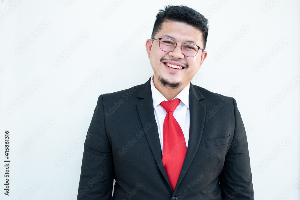 Handsome young business man wear glasses red tie in a suit and west.