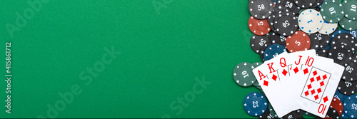 Cards and poker chips on a green background