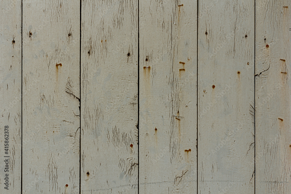 Fototapeta premium Texture of rural stained exterior vertical oak planks of country shed. Old dirty rough siding of gnarled surface wooden paneling. Rustic veined facing lumber fence of hard boards for 3D style design