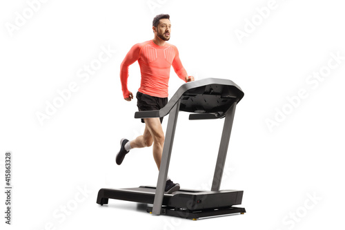 Full length shot of a fit young man running on a treadmill