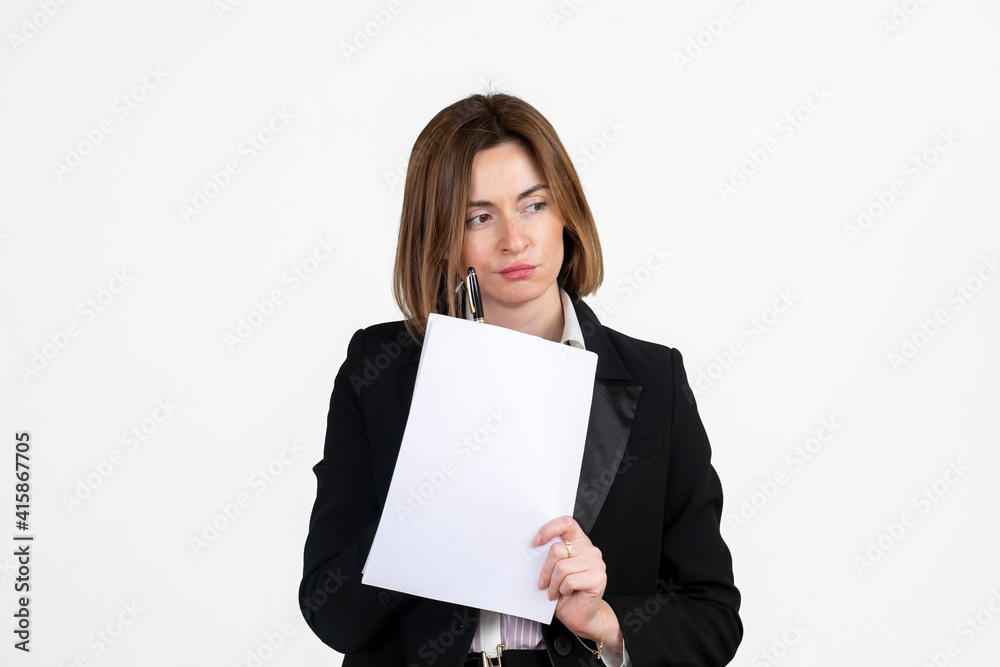 Thoughtful attractive business woman in black suit holding documents in her hand isolated on white Thoughtful attractive business woman in black suit holding documents in her hand isolated on white