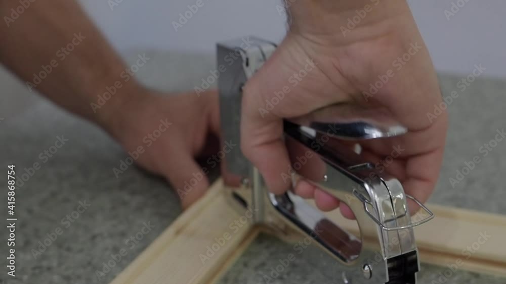 Person fixing wood planks with wood stapler in factory. Slow motion Close up shot. Person fixing wood planks with wood stapler in factory. Slow motion Close up shot.