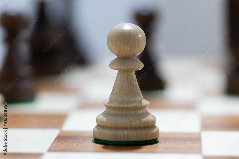 Playing wooden chess on a chessboard. Tactics and strategy. Black and white shapes. Playing wooden chess on a chessboard. Tactics and strategy. Black and white shapes.