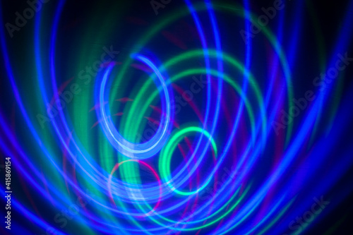 abstract background, colored circles on a black background, circles in motion