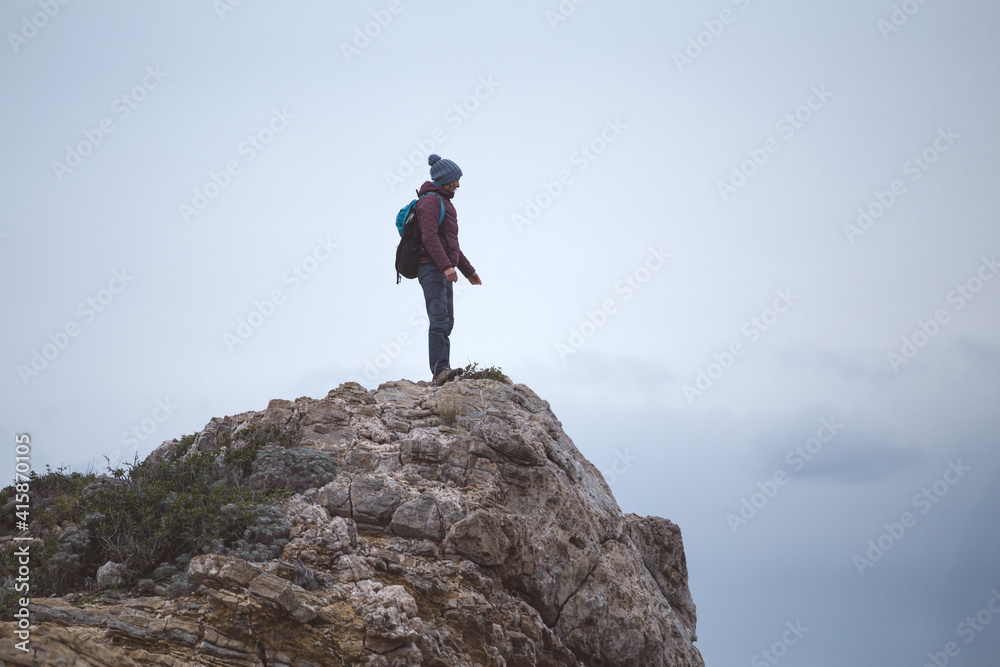 silhouette of a man with a backpack on the mountain