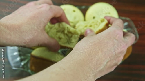 top view closeup woman by hands show braked white muffin with coconut