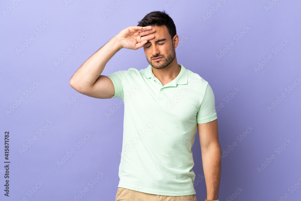 Young handsome man isolated on purple background with tired and sick expression Young handsome man isolated on purple background with tired and sick expression