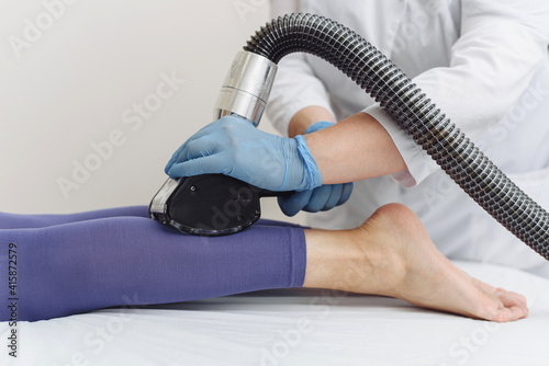 Young woman doing LPG leg procedure. Advertising. Lymphatic drainage massage LPG apparatus process