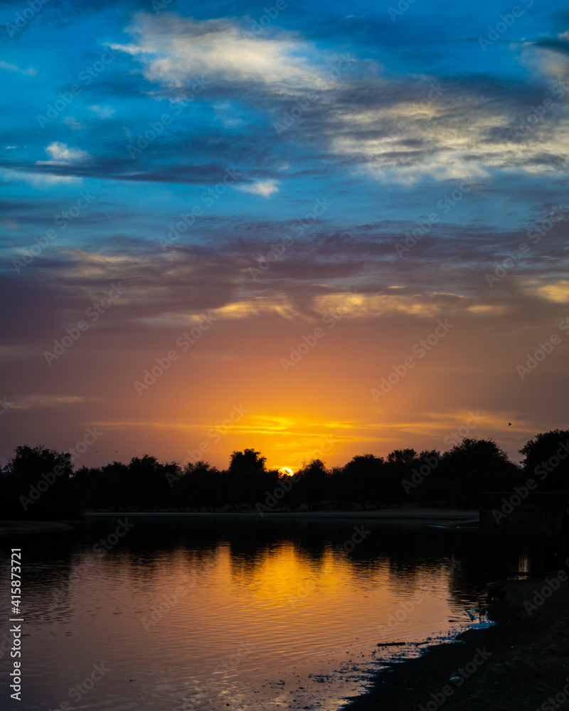 Fototapeta premium Sunrise over the river at Qudra Lake