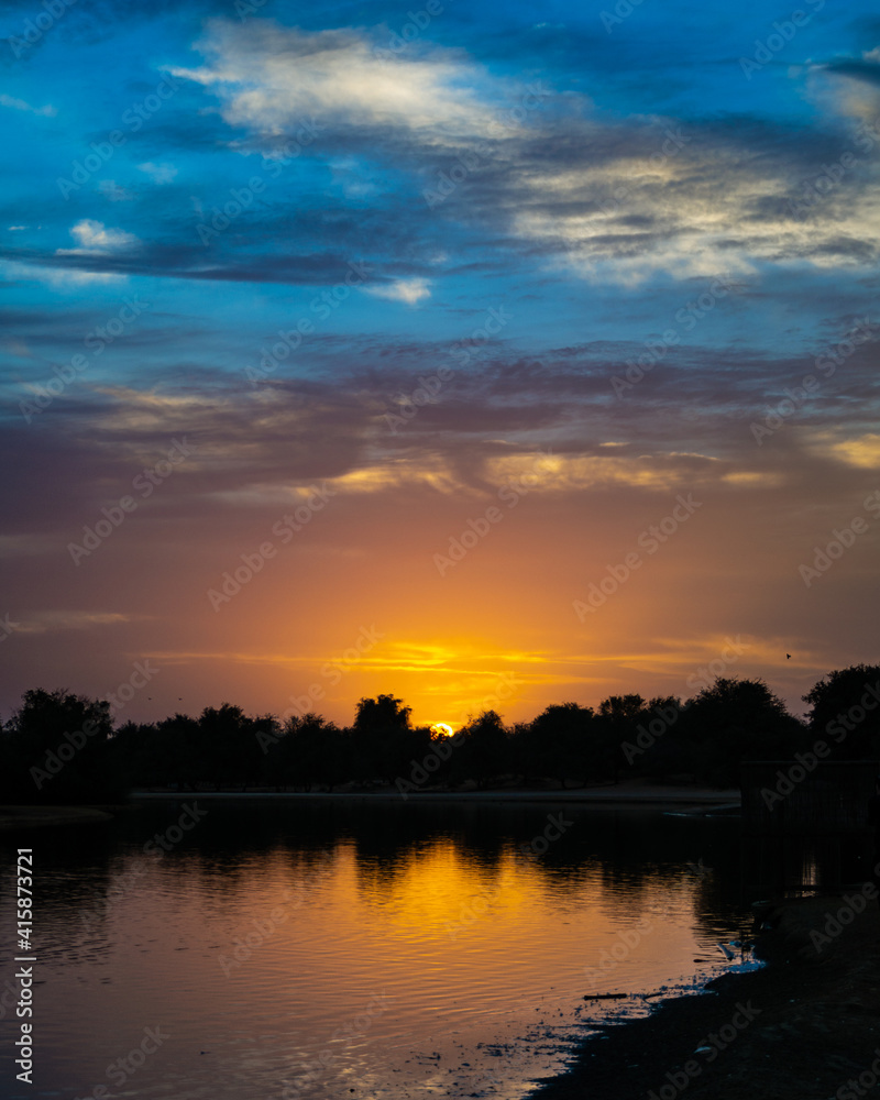 Sunrise over the river at Qudra Lake