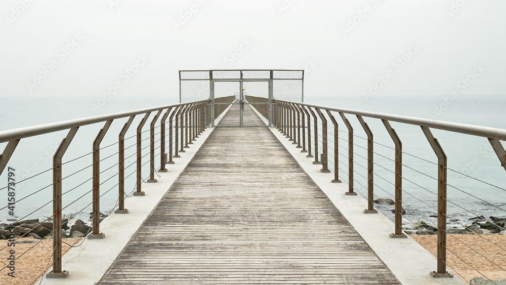 Puerta en un puente peatonal que da al mar para contemplar 