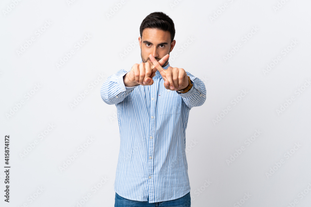 Young handsome man over isolated background making stop gesture with her hand to stop an act Young handsome man over isolated background making stop gesture with her hand to stop an act