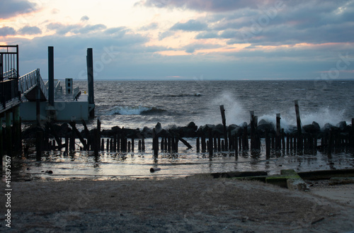 Choppy seas of Sandy Hook Bay hit the shore of Sandy Hook s Fort Hancock under a colorful cloudy sunset -15