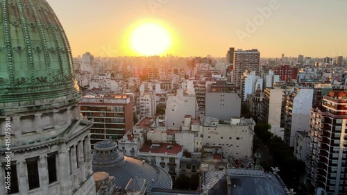 Aerial dolly out flying over Balvanera neighborhood revealing Argentine Congress building at sunset, Buenos Aires photo