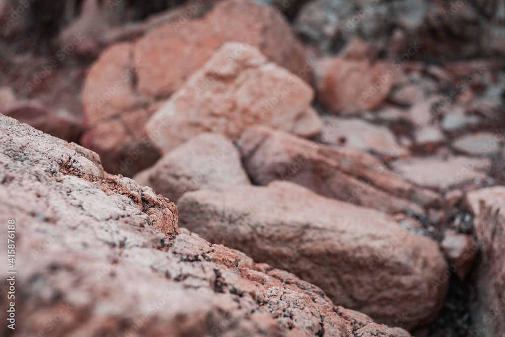 Fototapeta premium Beautiful sunset seascape in Italy, Sardinia island. Red and pink rocks, wind erosion, geology stratification, air oxydation. Teal and orange lighting, 