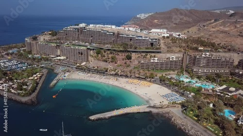 Summer flight near the sunny beach in Puerto Rico de Gran Canaria, Canary islands, Spain photo