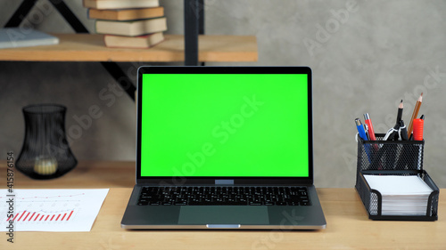 Принти на полотні Close up modern laptop computer display mock up chroma key green screen standing on table working office business workplace